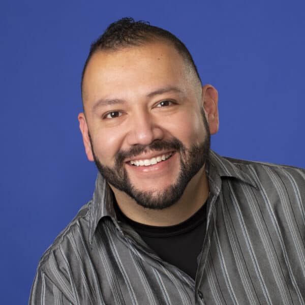 Jones family ortho invisalign Photo of man smiling infront of blue background
