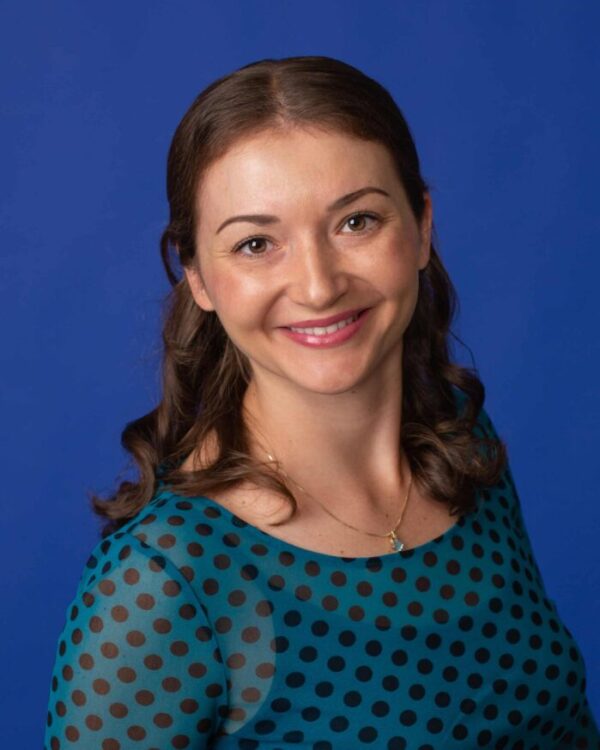 Adult-orthodontics-jones-family-smiling-patient Adult patient smiling into camera with straight teeth