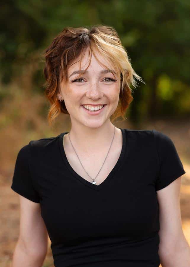 Jones-family-orthodontics-beautiful-young-woman-straight-teeth-short-hair Photo of girl smiling outside