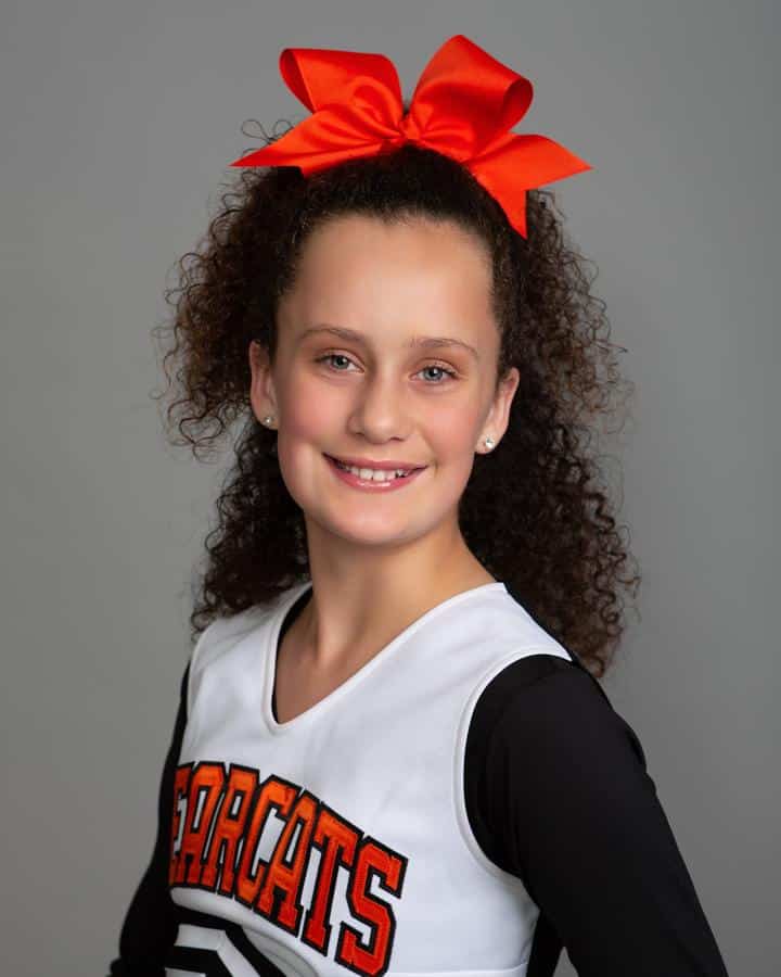 Jones-family-orthodontics-young-cheerleader-girl-straight-teeth Photo of young girl smiling
