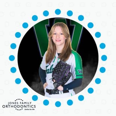 Activities teens can still do while undergoing orthodontic treatment 2 Girl with braces wearing softball glove and uniform, representing orthodontic treatment