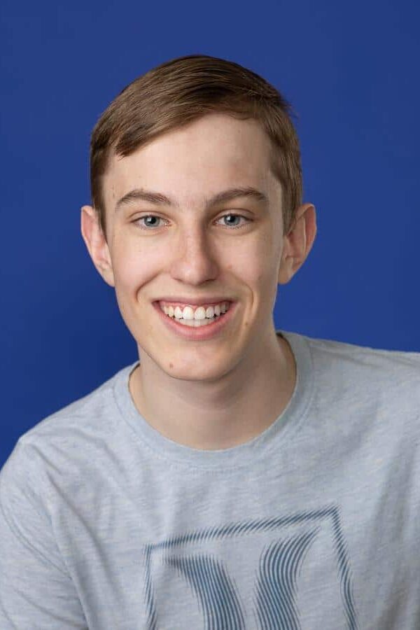 Jones-orthodontics-patient-post-treatment Teen smiling after orthodontic treatment with straight teeth