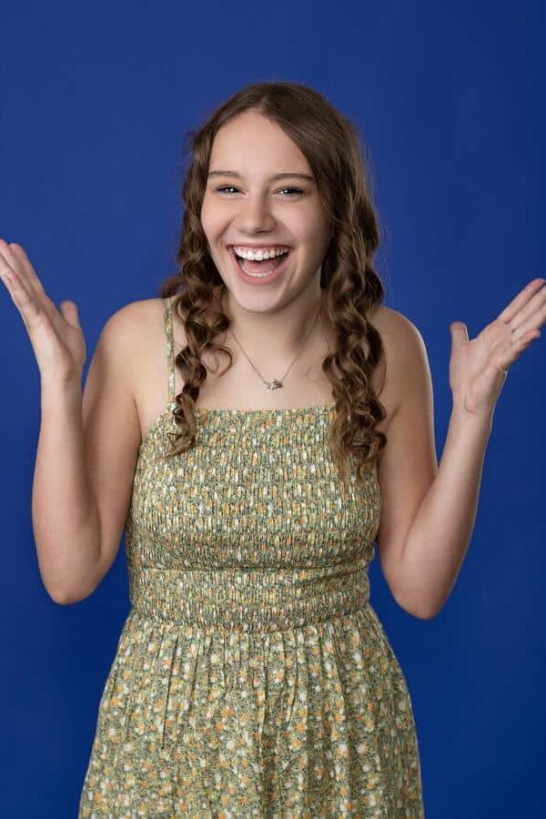 Teenage-girl-patient-smiling-post-orthodontic-treatment Smiling female patient after orthodontic treatment with straight teeth