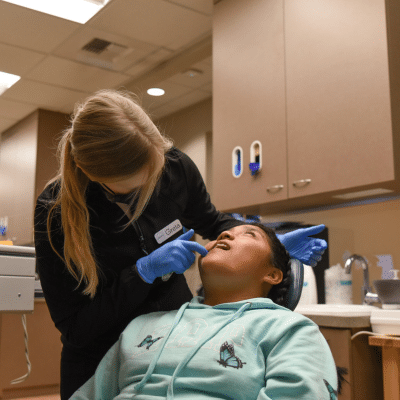 Celebrate national orthodontic health month: orthodontic treatment in monroe wa 9 Jones orthodontics team member working on a patient's teeth, representing orthodontic treatment in monroe wa
