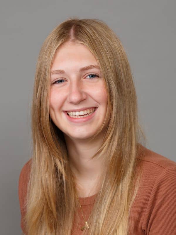 Jones-family-orthodontics-teagan Young girl with brown hair smiling in tan shirt at jones family orthodontics