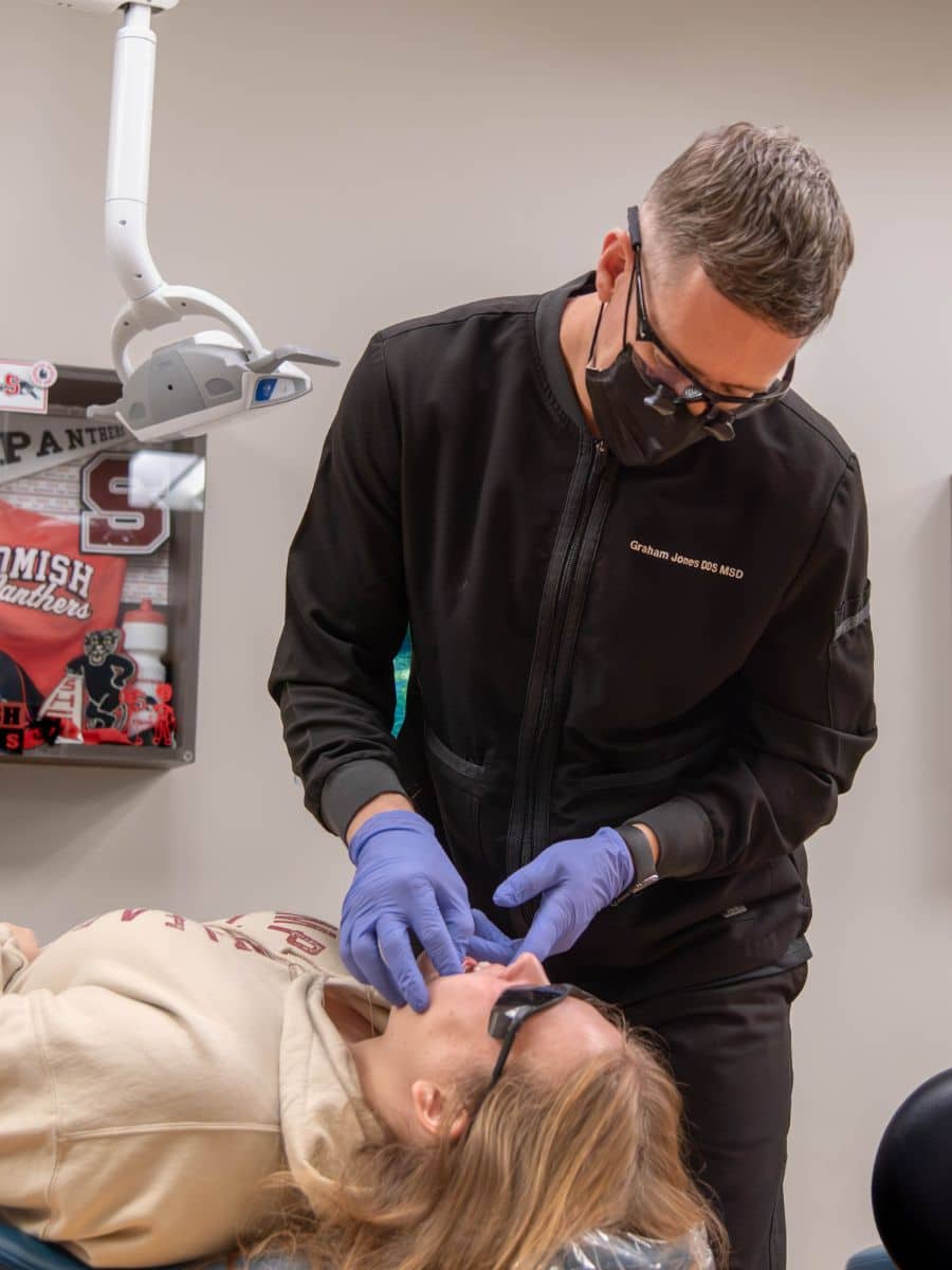 Jones-family-orthodontics-after-hours-scheduling Orthodontist working on a female patient during an after-hours appointment at jones family orthodontics