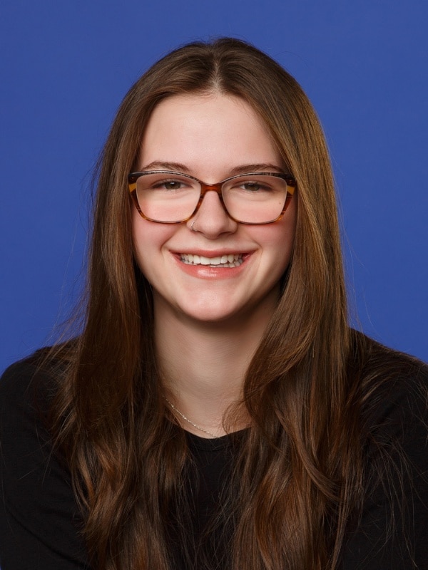 Jones-family-orthodontics-allyson Young girl with brown hair and glasses smiling at jones family orthodontics in monroe, wa