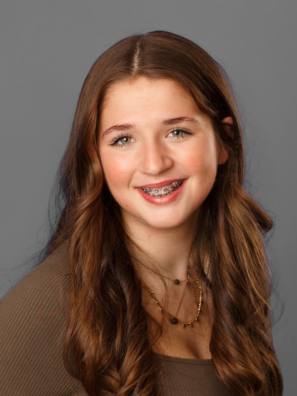 Jones-family-orthodontics-everly Young girl with brown hair smiling with braces at jones family orthodontics in monroe, wa