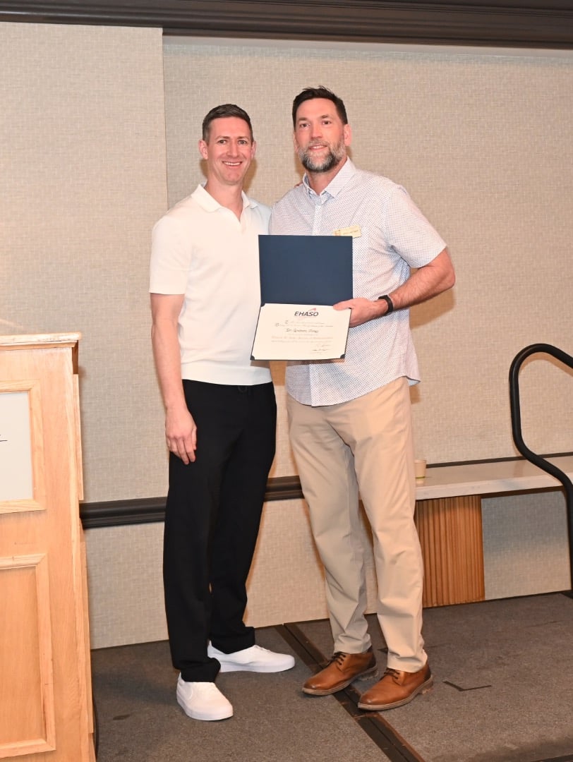 Jones family orthodontics timeline 17 Dr. Hartman presenting dr. Jones with an ehaso membership certificate during a professional healthcare event
