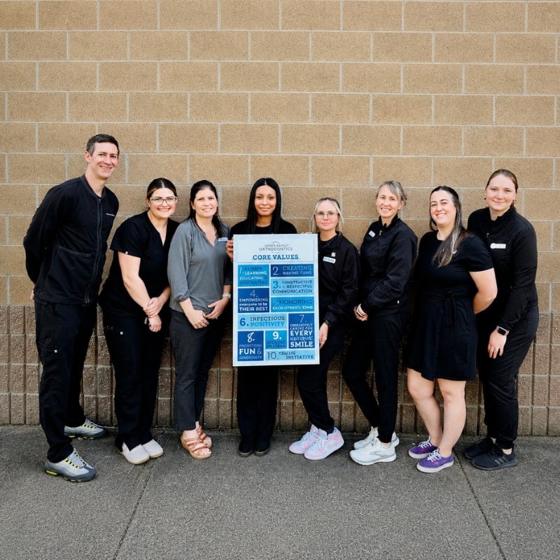 Jones-family-ortho-updated-group-photo Jones family orthodontics team holding core values sign while providing braces and invisalign care in monroe, wa.